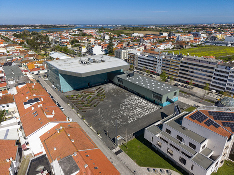 Aerial view of the modern architecture amongst residential buildings with red tiled roofs contrasting against the blue sky Espinho Portugal. Aerial view of the modern architecture amongst residential buildings with red tiled roofs contrasting against the blue sky Espinho Portugal.