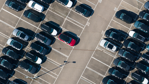 Aerial view of the JLR National Distribution Centre parking lot filled with numerous parked vehicles including a red car in Baxterley England United Kingdom. Aerial view of the JLR National Distribution Centre parking lot filled with numerous parked vehicles including a red car in Baxterley England United Kingdom.