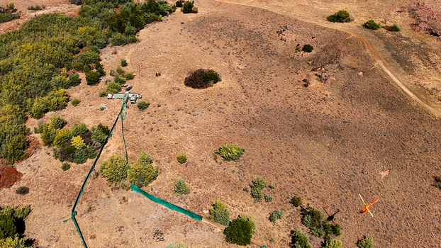 Aerial view of a helicopter flying over the dry arid landscape with sparse vegetation shrubs and a dirt road in Waterberg District Municipality Limpopo South Africa. Aerial view of a helicopter flying over the dry arid landscape with sparse vegetation shrubs and a dirt road in Waterberg District Municipality Limpopo South Africa.