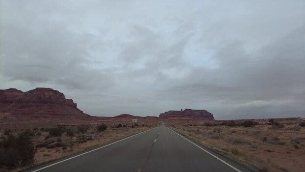 View of desert road and red rock formations United States. View of desert road and red rock formations United States.