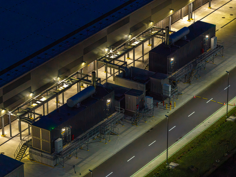 Aerial view of an advanced data center facility with modular units and industrial infrastructure illuminated at night in Warsaw Masovian Voivodeship Poland. Aerial view of an advanced data center facility with modular units and industrial infrastructure illuminated at night in Warsaw Masovian Voivodeship Poland.
