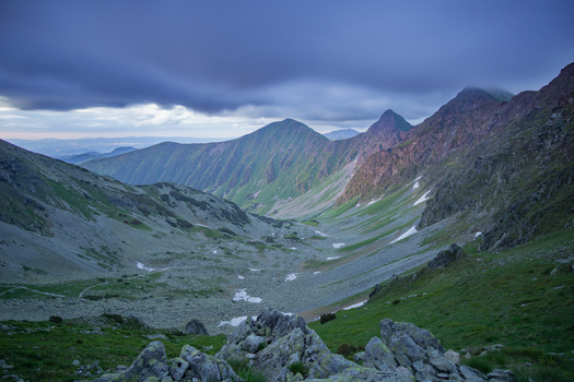 View of Smutne sedlo in Western Tatras with rocky peaks and green alpine meadows under a dramatic cloudy sky in Ziar Zilina Region Slovakia. View of Smutne sedlo in Western Tatras with rocky peaks and green alpine meadows under a dramatic cloudy sky in Ziar Zilina Region Slovakia.