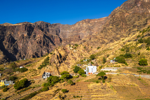 Aerial view of the rugged mountainous landscape of Santo Antao with terraced fields and small buildings nestled in the valley of Alto Mira Porto Novo Cabo Verde.
