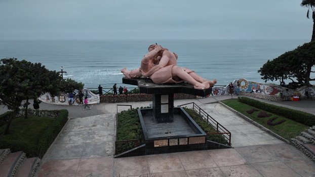 Aerial view of the El Beso sculpture in Love Park overlooking the Pacific Ocean with coastal cliffs and gardens in Miraflores Provincia de Lima Peru.