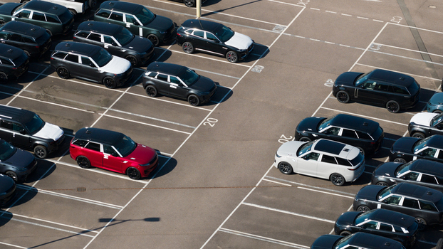 Aerial view of the JLR National Distribution Centre parking lot filled with rows of new SUVs including models with protective white film in Baxterley England United Kingdom. Aerial view of the JLR National Distribution Centre parking lot filled with rows of new SUVs including models with protective white film in Baxterley England United Kingdom.