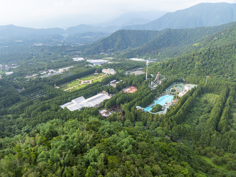 Aerial view of the Formosan Aboriginal Culture Village theme park nestled among lush green mountains and dense forests in Yuchi Township Nantou County Taiwan. Aerial view of the Formosan Aboriginal Culture Village theme park nestled among lush green mountains and dense forests in Yuchi Township Nantou County Taiwan.