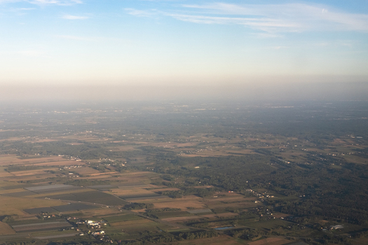 Aerial view of a sprawling landscape where fields and forests meet under a pale sky creating a textured tapestry of rural Poland Masovian Voivodeship Poland. Aerial view of a sprawling landscape where fields and forests meet under a pale sky creating a textured tapestry of rural Poland Masovian Voivodeship Poland.