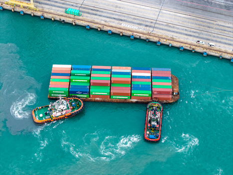 Butterworth Malaysia 22 September 2026 Aerial view of Evergreen containers on a barge being maneuvered by two tugboats at the North Butterworth Container Terminal. Butterworth Malaysia 22 September 2026 Aerial view of Evergreen containers on a barge being maneuvered by two tugboats at the North Butterworth Container Terminal.