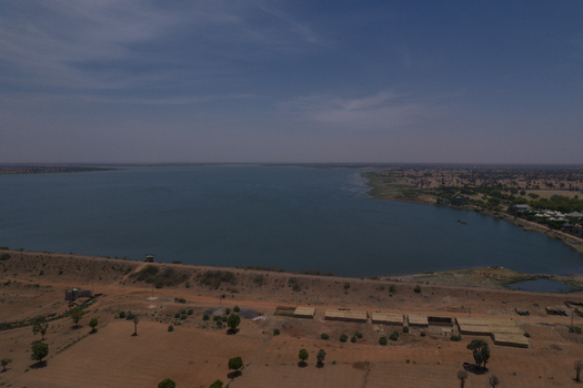 Aerial view of the Minjibir Dam reservoir surrounded by arid plains and small rural structures in Kano Kano State Nigeria. Aerial view of the Minjibir Dam reservoir surrounded by arid plains and small rural structures in Kano Kano State Nigeria.