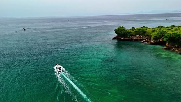 Aerial view of a boat cruising near the coast of Bali Indonesia.