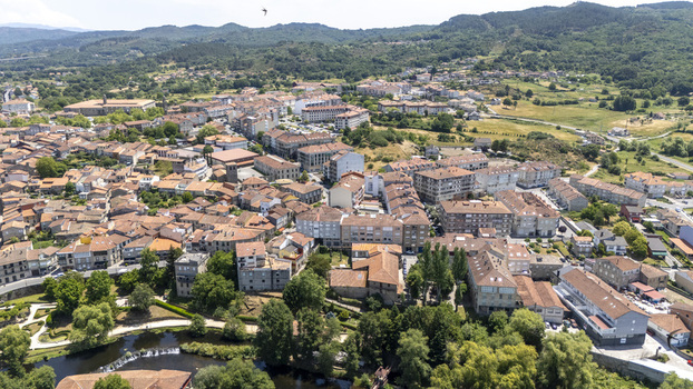 Aerial view of the historic town of Allariz with traditional stone buildings terracotta rooftops and lush green surroundings in Allariz Province of Ourense Spain. Aerial view of the historic town of Allariz with traditional stone buildings terracotta rooftops and lush green surroundings in Allariz Province of Ourense Spain.