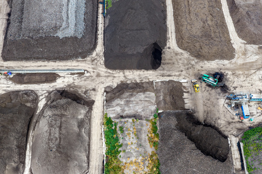 Aerial view of a compost processing facility with large piles of organic waste and heavy machinery Netherlands.