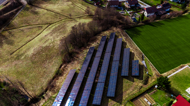 Aerial view of solar panels gleaming against the backdrop of the Windischgarsten valley a patchwork of fields and scattered houses Windischgarsten Upper Austria Austria. Aerial view of solar panels gleaming against the backdrop of the Windischgarsten valley a patchwork of fields and scattered houses Windischgarsten Upper Austria Austria.