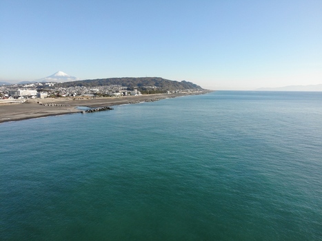 Aerial view of Mount Fuji rising above the coastline of Suruga Bay with the city of Shizuoka Shizuoka Japan.