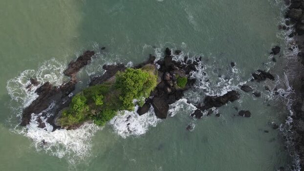 Aerial view of Karang Agung Beach rocky islet and waves Indonesia. Aerial view of Karang Agung Beach rocky islet and waves Indonesia.