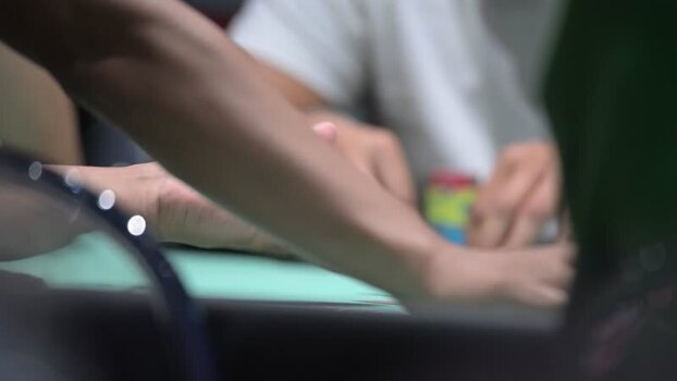 View of hands playing poker with chips on a green table Portugal. View of hands playing poker with chips on a green table Portugal.