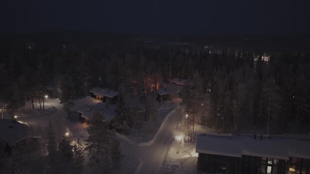 Aerial view of Luosto cabins in snowy forest Finland.
