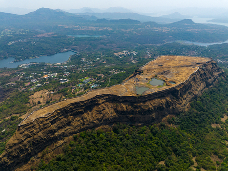 Aerial view of Korigad Fort with its historic stone walls and plateau ponds surrounded by lush green hills and valleys in Peth Shahapur Maharashtra India. Aerial view of Korigad Fort with its historic stone walls and plateau ponds surrounded by lush green hills and valleys in Peth Shahapur Maharashtra India.