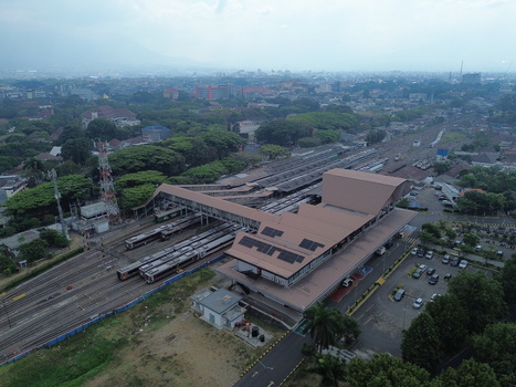 Aerial view of Stasiun Malang Kota Baru with railway tracks trains and surrounding urban landscape in Kecamatan Klojen Jawa Timur Indonesia.