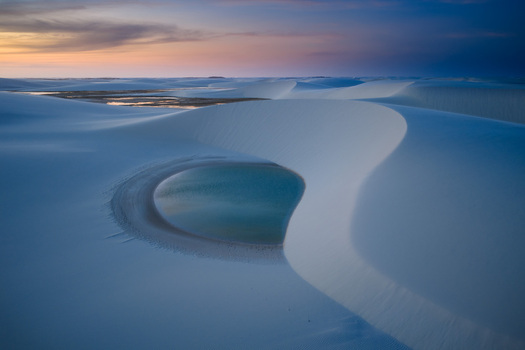 Aerial view of the white sand dunes and turquoise lagoons of Parque Nacional dos Lencois Maranhenses during a soft sunset Lencois Maranhenses MA Brazil. Aerial view of the white sand dunes and turquoise lagoons of Parque Nacional dos Lencois Maranhenses during a soft sunset Lencois Maranhenses MA Brazil.