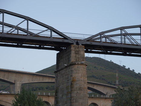 View of the metal truss bridge supported by a stone pier in Peso da Regua Vila Real District Portugal.