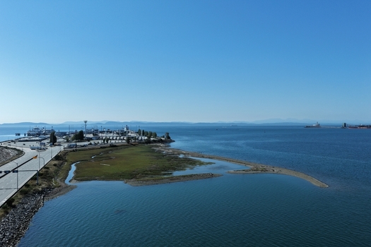 Aerial view of BC Ferries Tsawwassen Toll Booth and terminal area with coastal landscape calm water and clear blue sky in Delta British Columbia Canada. Aerial view of BC Ferries Tsawwassen Toll Booth and terminal area with coastal landscape calm water and clear blue sky in Delta British Columbia Canada.