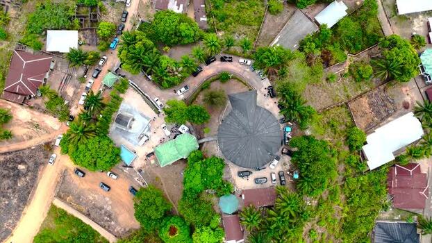 Aerial view of a circular building and settlement Nigeria. Aerial view of a circular building and settlement Nigeria.