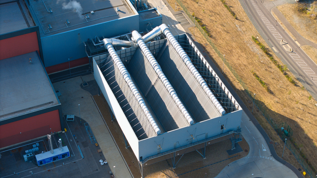 Aerial view of the Rookery South ERF industrial facility featuring large cooling structures and metal ducting on the rooftops in Stewartby England United Kingdom. Aerial view of the Rookery South ERF industrial facility featuring large cooling structures and metal ducting on the rooftops in Stewartby England United Kingdom.