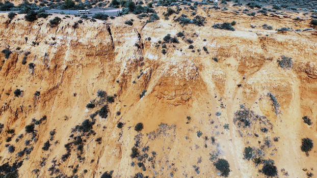 Aerial view of the Matthew Flinders Red Cliff Lookout featuring dramatic red sandstone cliffs and sparse desert vegetation in Port Augusta West South Australia Australia. Aerial view of the Matthew Flinders Red Cliff Lookout featuring dramatic red sandstone cliffs and sparse desert vegetation in Port Augusta West South Australia Australia.