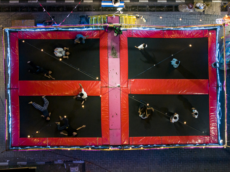 Aerial view of GOR Gelarsena Klaten Night Market with children playing on a large illuminated trampoline at night in Kecamatan Klaten Utara Jawa Tengah Indonesia. Aerial view of GOR Gelarsena Klaten Night Market with children playing on a large illuminated trampoline at night in Kecamatan Klaten Utara Jawa Tengah Indonesia.