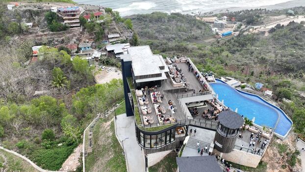 Kecamatan Purwosari Indonesia 23 November 2023 Aerial view of Obelix Sea View with its infinity pool modern restaurant terrace and surrounding lush hills overlooking the ocean. Kecamatan Purwosari Indonesia 23 November 2023 Aerial view of Obelix Sea View with its infinity pool modern restaurant terrace and surrounding lush hills overlooking the ocean.