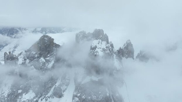 Aerial view of snowy peaks in Parco Naturale Paneveggio Italy.
