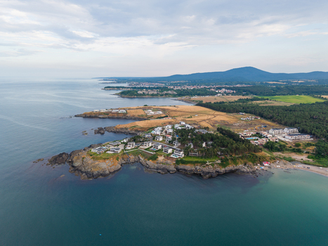 Aerial view of Arapya featuring modern coastal villas nestled among trees and rocky cliffs along the Black Sea in Burgas Bulgaria. Aerial view of Arapya featuring modern coastal villas nestled among trees and rocky cliffs along the Black Sea in Burgas Bulgaria.