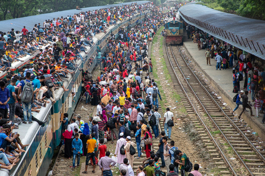 Dhaka Bangladesh 15 June 2018 View of the crowded Airport Railway Station with thousands of people sitting on train roofs and platforms. Dhaka Bangladesh 15 June 2018 View of the crowded Airport Railway Station with thousands of people sitting on train roofs and platforms.