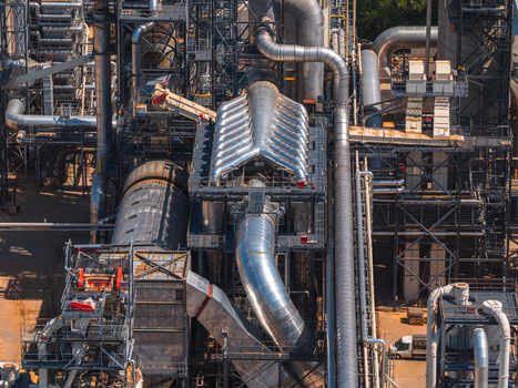 Aerial view of the complex network of industrial pipes metal structures and machinery at a factory in Jihlava Vysocina Region Czechia.