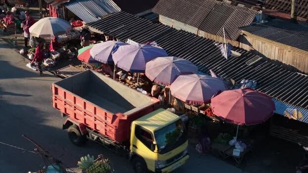 Aerial view of a street market with a yellow truck Indonesia.