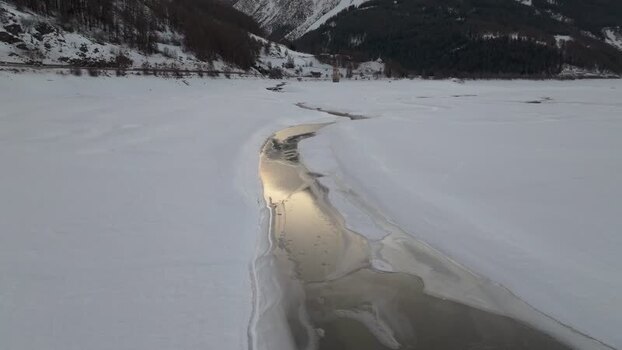 Aerial view of the frozen Reschensee church tower in Italy. Aerial view of the frozen Reschensee church tower in Italy.