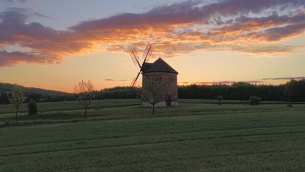 Aerial view of a historic windmill in green fields at sunset Czechia. Aerial view of a historic windmill in green fields at sunset Czechia.