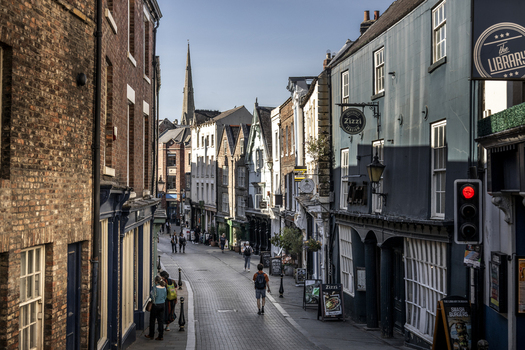 Durham England United Kingdom 13 July 2026 View of a historic street in Durham with traditional brick buildings shops and pedestrians walking along the pavement. Durham England United Kingdom 13 July 2026 View of a historic street in Durham with traditional brick buildings shops and pedestrians walking along the pavement.