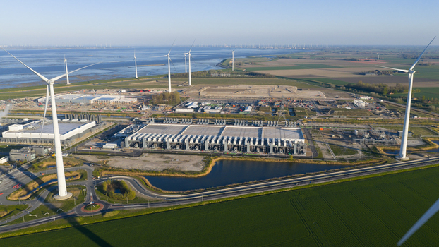 Aerial view of the Google Data Center surrounded by wind turbines and green fields near the coast in Eemshaven Groningen Netherlands. Aerial view of the Google Data Center surrounded by wind turbines and green fields near the coast in Eemshaven Groningen Netherlands.