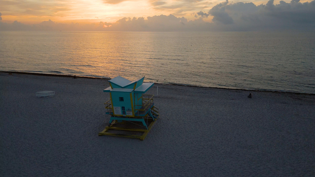 Aerial view of a colorful lifeguard tower on the sandy beach at sunset in Miami Beach Florida United States. Aerial view of a colorful lifeguard tower on the sandy beach at sunset in Miami Beach Florida United States.