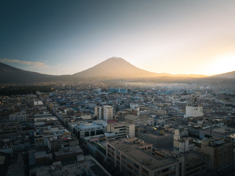 Aerial view of the city of Arequipa with the Misti volcano in the background featuring urban architecture rooftops and the soft light of sunrise in Arequipa Arequipa Peru. Aerial view of the city of Arequipa with the Misti volcano in the background featuring urban architecture rooftops and the soft light of sunrise in Arequipa Arequipa Peru.