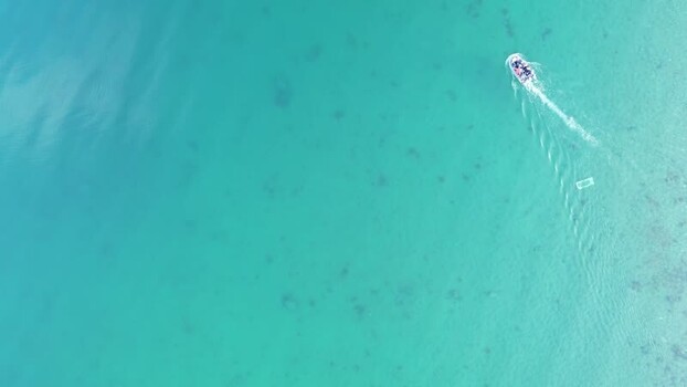 Aerial view of a motorboat in turquoise waters Norway.