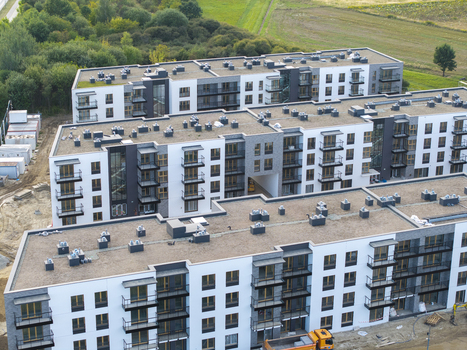 Aerial view of modern apartment buildings with flat roofs and balconies in a residential complex under construction in Poland. Aerial view of modern apartment buildings with flat roofs and balconies in a residential complex under construction in Poland.