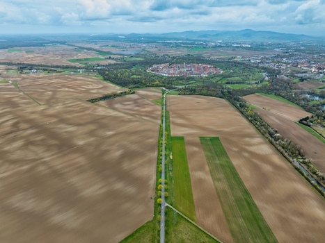 Aerial view of the star shaped fortress city a testament to military architecture amidst the agricultural fields Neuf Brisach Grand Est France.