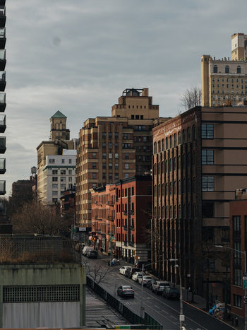 View of the historic Brooklyn streetscape featuring brick buildings parked cars and urban architecture in Kings County New York United States.