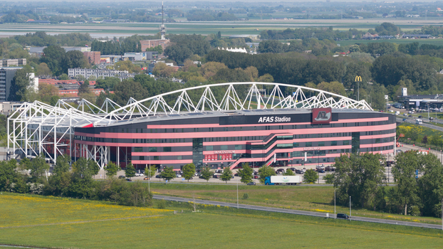Alkmaar Netherlands 05 May 2026 Aerial view of AFAS stadium featuring its distinctive white lattice roof and red facade surrounded by green fields and urban infrastructure.