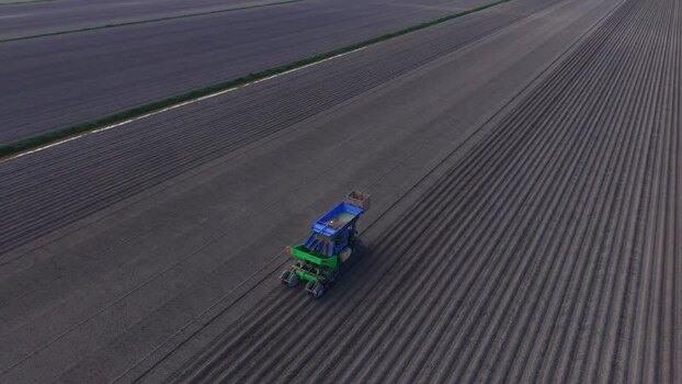 Aerial view of a tractor working in a field in Middenbeemster Netherlands.