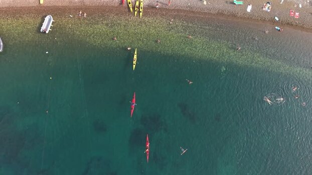 Aerial view of kayaks and swimmers at a beach in Portoferraio Italy.