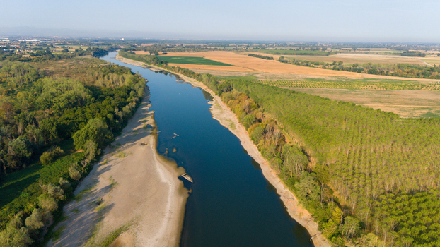 Aerial view of the Po River with low water levels caused by a summer heatwave exposing wide sediment beaches and the riverbed in Castelvetro Piacentino Emilia Romagna Italy. Aerial view of the Po River with low water levels caused by a summer heatwave exposing wide sediment beaches and the riverbed in Castelvetro Piacentino Emilia Romagna Italy.